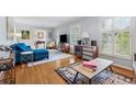Bright living room featuring hardwood floors, plantation shutters, and stylish furnishings at 500 Read Ln, Atlanta, GA 30328