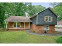 Inviting front exterior showcasing brick and siding details, a well-manicured lawn, and a cozy entrance at 588 Benson Hurst Sw Dr, Mableton, GA 30126
