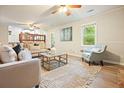 Spacious living room with ample seating, natural light, and neutral color palette at 588 Benson Hurst Sw Dr, Mableton, GA 30126