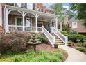 Inviting front porch with white railings and steps, complemented by a tiered fountain at 2630 Weddington Ne Pl, Marietta, GA 30068