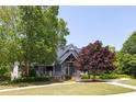 Community clubhouse boasts lush landscaping, a covered entry, and a welcoming front porch at 313 Willow Cv, Canton, GA 30114