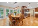Eat-in kitchen with stainless steel appliances, wood cabinets, hardwood floors, and glass doors to the backyard at 4507 Reva Way, Marietta, GA 30066