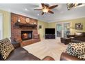 Inviting living room with a brick fireplace, plush seating, carpet floors, and a ceiling fan at 4507 Reva Way, Marietta, GA 30066