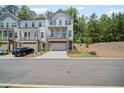 Charming two-story townhome with a stone-accented base, private porch, and driveway at 507 Bishop Ln, Woodstock, GA 30188