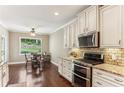 This kitchen features granite countertops, stainless steel appliances, and a breakfast nook at 59 Grand Georgian Ne Ct, Cartersville, GA 30121