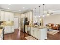Bright kitchen with stainless steel appliances, granite countertops, and hardwood floors at 59 Grand Georgian Ne Ct, Cartersville, GA 30121