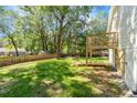 Large backyard featuring a wooden deck, mature trees and newly installed wooden fence at 1363 Diamond Se Ave, Atlanta, GA 30316