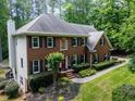 Lovely brick home with lush landscaping, mature trees, and a well-manicured lawn at 4673 Jefferson Township Pl, Marietta, GA 30066