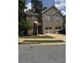 Charming two-story brick home featuring a well-manicured lawn and attached garage at 7055 Blairs View Dr # 1, Austell, GA 30168