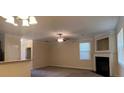 Open-concept living room featuring carpet, a fireplace, and windows with natural light at 7055 Blairs View Dr # 1, Austell, GA 30168