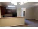 View of open-concept living space with kitchen bar, cabinets, and appliances at 7055 Blairs View Dr # 1, Austell, GA 30168