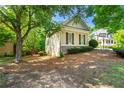 View of the home's rear exterior featuring stone and siding under a shade tree at 931 Windsor Creek Dr, Grayson, GA 30017
