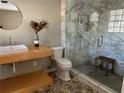 Modern bathroom featuring a marble shower and floating vanity with beautiful natural light at 1053 Allgood Rd, Stone Mountain, GA 30083