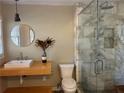 Modern bathroom featuring a marble shower and floating vanity with a large mirror at 1053 Allgood Rd, Stone Mountain, GA 30083