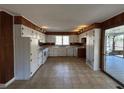 Bright kitchen with white cabinetry and a view to the back porch with a swing at 1053 Allgood Rd, Stone Mountain, GA 30083