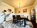 Cozy dining room features elegant wainscoting, modern light fixture, and stylish decor creating a welcoming space at 2579 Wimberley Pine Ct, Dacula, GA 30019