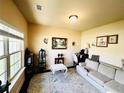 Comfortable living room with a cozy sofa, stylish rug, and large window offering natural light and a relaxing ambiance at 2579 Wimberley Pine Ct, Dacula, GA 30019