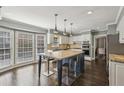Spacious kitchen features a large island, stainless steel appliances, and white cabinetry with modern fixtures at 3715 Borning Ct, Johns Creek, GA 30022