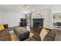 Cozy living room features a fireplace, dark trim, and ample seating for guests and Gathering at 3715 Borning Ct, Johns Creek, GA 30022