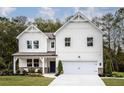 Beautiful two-story home with white siding, a charming front porch, and well-maintained landscaping at 129 Henley St, Canton, GA 30114