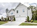Elegant two-story farmhouse style home with white vertical siding and a well-manicured lawn at 129 Henley St, Canton, GA 30114