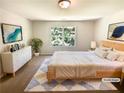 Bright bedroom with a large window, modern decor, and a cozy rug at 1958 Millstream Holw, Conyers, GA 30012