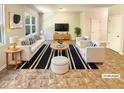 Staged living room with bright natural light, contemporary furniture, and decor at 1958 Millstream Holw, Conyers, GA 30012