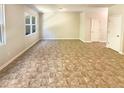 Spacious living room with a large window and neutral flooring at 1958 Millstream Holw, Conyers, GA 30012