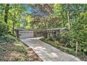 Charming ranch home featuring a well-manicured lawn, mature trees, and an attached two-car garage at 6590 Williamson Ne Dr, Atlanta, GA 30328