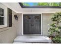 Elegant double front doors framed by decorative sidelights, enhancing curb appeal with a welcoming entrance at 6590 Williamson Ne Dr, Atlanta, GA 30328