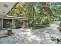 Welcoming front entrance with decorative double doors, charming accents, and mature trees at 6590 Williamson Ne Dr, Atlanta, GA 30328