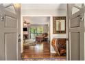 Inviting living room, featuring hardwood floors, a cozy seating area, and natural light, viewed from the front doors at 6590 Williamson Ne Dr, Atlanta, GA 30328