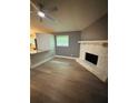 Inviting living room featuring hardwood floors and a cozy stone fireplace at 6832 Shangrila Way, Riverdale, GA 30296