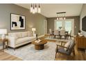 Tastefully staged living and dining room area with contemporary furniture and decor at 6832 Shangrila Way, Riverdale, GA 30296
