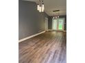 Bright open-concept living space with modern lighting and wood flooring at 6832 Shangrila Way, Riverdale, GA 30296
