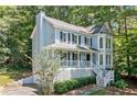 Charming two-story home boasts a covered porch and inviting curb appeal nestled amongst mature trees at 3 Maplelake Dr, Acworth, GA 30101