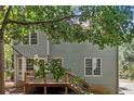 Two-story home with a wood deck and steps leading down to the backyard, surrounded by lush greenery at 3 Maplelake Dr, Acworth, GA 30101