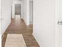 Bright hallway with hardwood floors leading to various rooms in the home at 3933 Fairhaven Rd, Lithia Springs, GA 30122
