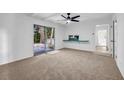 Bedroom featuring neutral carpet, a ceiling fan, and sliding glass doors to a patio at 4274 Smithsonia Ct, Tucker, GA 30084