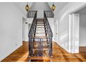 Bright foyer features hardwood floors, a staircase with a decorative railing, and pendant lighting at 4274 Smithsonia Ct, Tucker, GA 30084