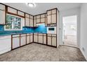 A functional kitchen with light wood cabinets, blue countertops, and classic appliances at 4274 Smithsonia Ct, Tucker, GA 30084