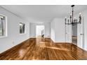 Bright living room with gleaming hardwood floors, a modern chandelier, and white walls at 4274 Smithsonia Ct, Tucker, GA 30084