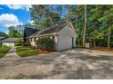 Home's exterior shows a garage, a paved driveway, and neat landscaping at 4274 Smithsonia Ct, Tucker, GA 30084
