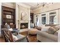Elegant living room showcasing a fireplace, custom bookshelves, and hardwood floors at 4830 Westgate Dr, Cumming, GA 30040