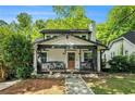 Charming home with a cozy front porch, stone foundation and a manicured lawn at 1227 Epworth Sw St, Atlanta, GA 30310