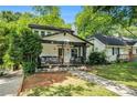 Charming home with a cozy front porch, stone foundation and a manicured lawn at 1227 Epworth Sw St, Atlanta, GA 30310