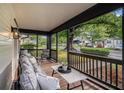 Relaxing covered front porch features comfortable seating and black railings at 1227 Epworth Sw St, Atlanta, GA 30310