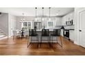 Eat-in kitchen with stainless steel appliances, kitchen island, and modern light fixtures at 2428 Mills Bnd, Decatur, GA 30034