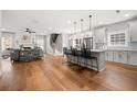 Open-concept kitchen with a large island, stainless steel appliances, and hardwood floors at 2428 Mills Bnd, Decatur, GA 30034