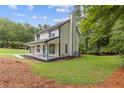 Charming home with a bright blue door and a covered porch, situated on a well-maintained lawn at 4657 Lou Ivy Rd, Peachtree Corners, GA 30096